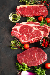 Variety of raw beef meat steaks for grilling.