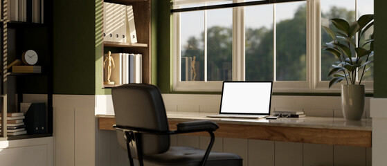Comfortable home working room interior with laptop mockup on table against the window