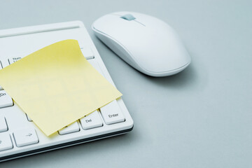 Yellow sticky note on computer keyboard