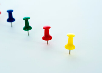 Push pins in a row isolated on white
