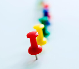 Push pins in a row isolated on white