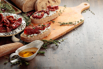 Bruschetta with ricotta, sun-dried tomatoes, and thyme.