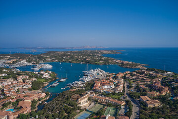 Fototapeta na wymiar Drone view Centre of Costa Smeralda. One of the most expensive resorts in the world. Aerial View of Porto Cervo, Italian seaside resort in northern Sardinia, Italy.