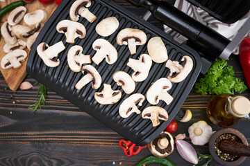 cooking at home on electric grill - champignon mushrooms