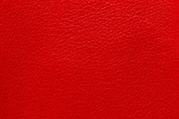 Close-up of a red leather and a textured background.