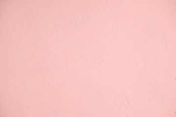 Saturated pastel light pink colored low contrast Concrete textured background. Empty colourful wall texture with copy space for text overlay and mockups. 2023, 2024 color trend