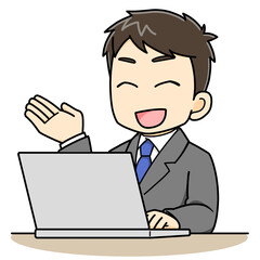 パソコンの前で説明や案内をするビジネスマン