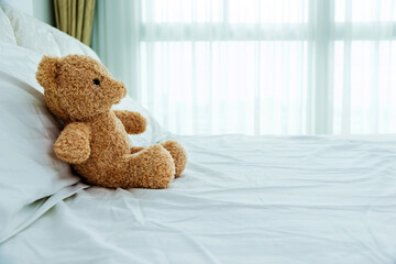 Teddy bear sitting in bed