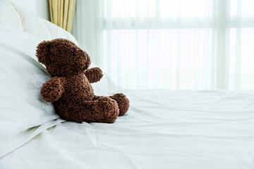 Teddy bear sitting in bed