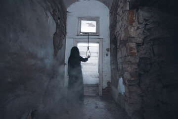 Scary ghost woman in haunted house with rope with a noose