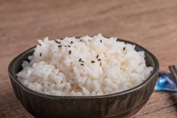 Cooked rice in a cup of black Thai jasmine rice