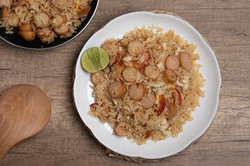 Sausage fried rice with egg and vegetables in white plate
