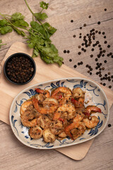 Fried prawns with black pepper and garlic in a white plate