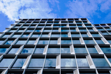 glass and aluminum office tower detail in diminishing perspective. abstract low angle view. modern...