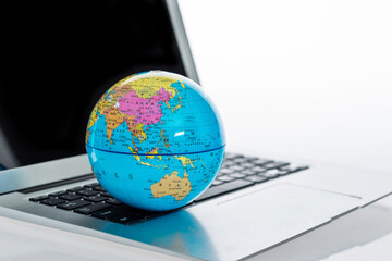 Close up of globe on laptop keyboard