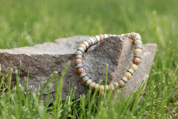 Two bracelets made of natural jasper stones beads. Handmade jewelry. Woman exoteric accessories. Talismans and amulets. Selective focus