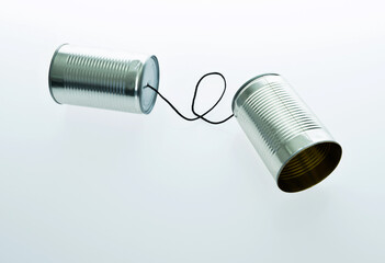 Tin can telephone with cord isolated on white background