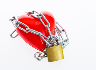Red heart locked with chain against white background