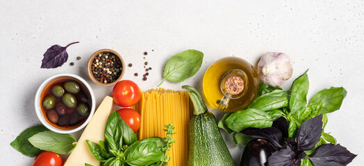 Italian food on white background. Fresh green and red basil, tomatoes, parmesan cheese, olives,...