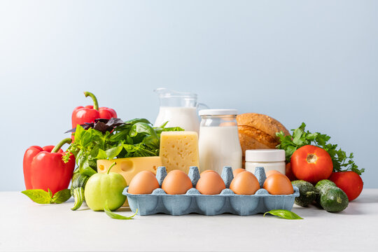 Groceries shopping or food delivery concept. Close up view of eggs, dairy products, vegetables, fruits, bread. Healthy eating