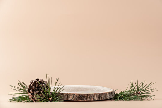 Wooden Podium With Branches Of Green Spruce And Cone On Beige Background. Concept Scene Stage Showcase, Product, Promotion Sale, Presentation, Beauty Cosmetic. Wooden Stand Studio Empty