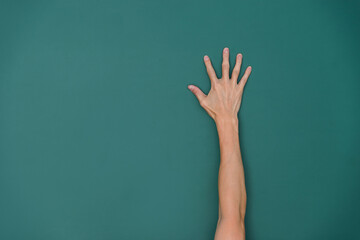 Raised hand in front of chalkboard