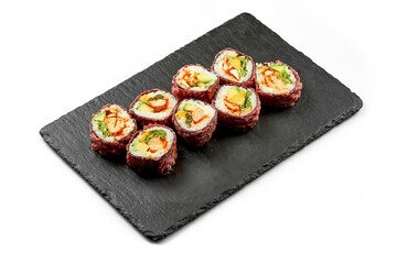 Sushi rolls with shrimp and avocado in a plate on a white background. Close-up. Selective focus