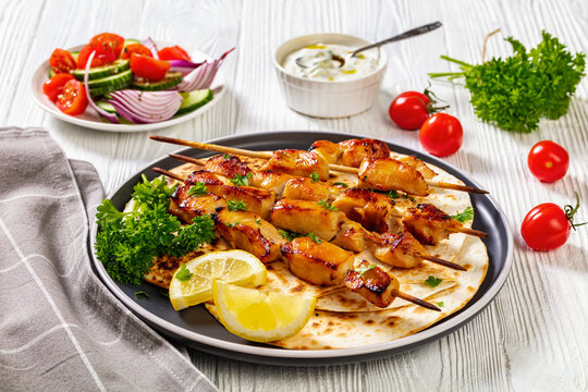 grilled chicken skewers with flatbreads, top view