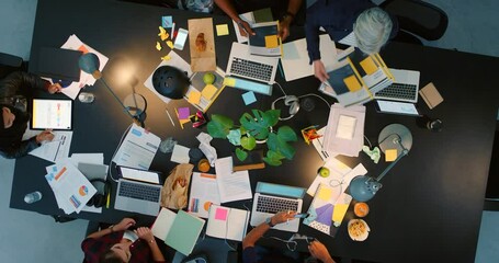 Top view, portfolio and digital marketing project meeting with manager giving out business documents to workers. Team of creative employees planning an seo strategy, branding and logo advertising