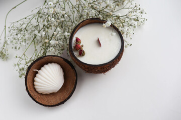 Fototapeta na wymiar original candle in coconut from natural soy wax with a wooden wick
