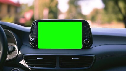 Green navigation screen on the dashboard from inside a modern new car.