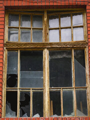 The broken window of an old building. Window with broken panes.