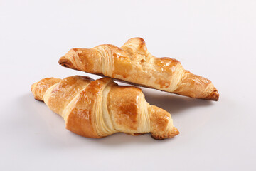 Yummy baguette sandwich with various vegetables and slices of cheese placed on white background in studio