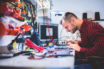 IT engineer technician repairing computer in electronics service shop