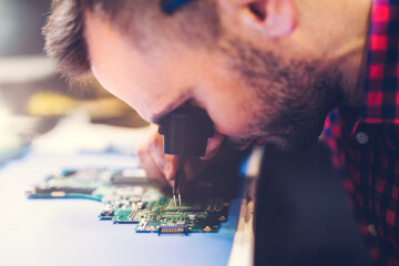 IT engineer technician repairing computer in electronics service shop