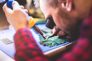 IT engineer technician repairing computer in electronics service shop