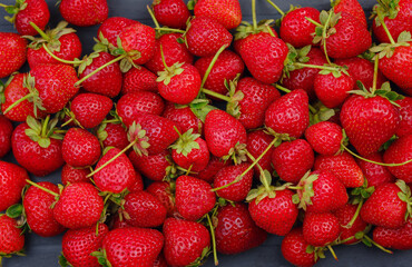 Fresh organic strawberries , over dark background. Vegetarian healthy food concept.