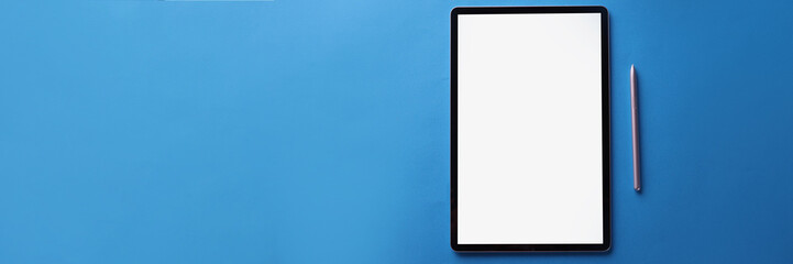 Set of black screen modern tablet device with reflection and silver pen on blue surface