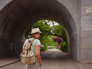 travel to summer Europe young asian woman. Woman having a great vacation in Switzerland, Basel. Lady walks along embankment of Rhine river