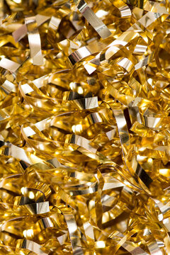 A Pile Of Laminated Tinsel Of Golden Color Close-up