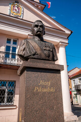 Bust of Jozef Pilsudski in front of the Town Hall. Konin, Greater Poland Voivodeship, Poland. - obrazy, fototapety, plakaty