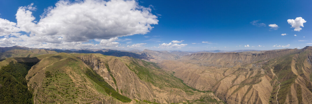 An ancient abandoned city is the village of Gamsutl on top of a mountain in Dagestan. A popular attraction. View from above from the drone. Vertical panorama. Tourist destination in Russia.