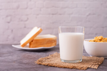 glass of milk and breakfast on kitchen table.