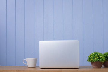 laptop on wood table with cup of coffee.