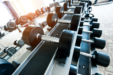 Rows of dumbbells in the gym