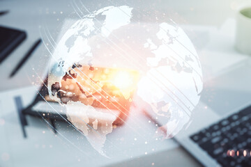 Abstract creative world map interface on calculator and laptop background, international trading...