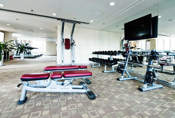 Fototapeta na wymiar Interior view of modern gym with equipment