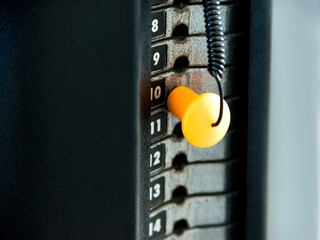 Close up of weight stack with yellow pin