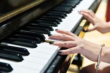 Woman hands on the piano keys
