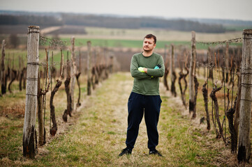 Portrait of man working on vineyard.